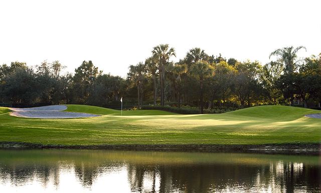 A green across the water at Arrowhead Golf Club